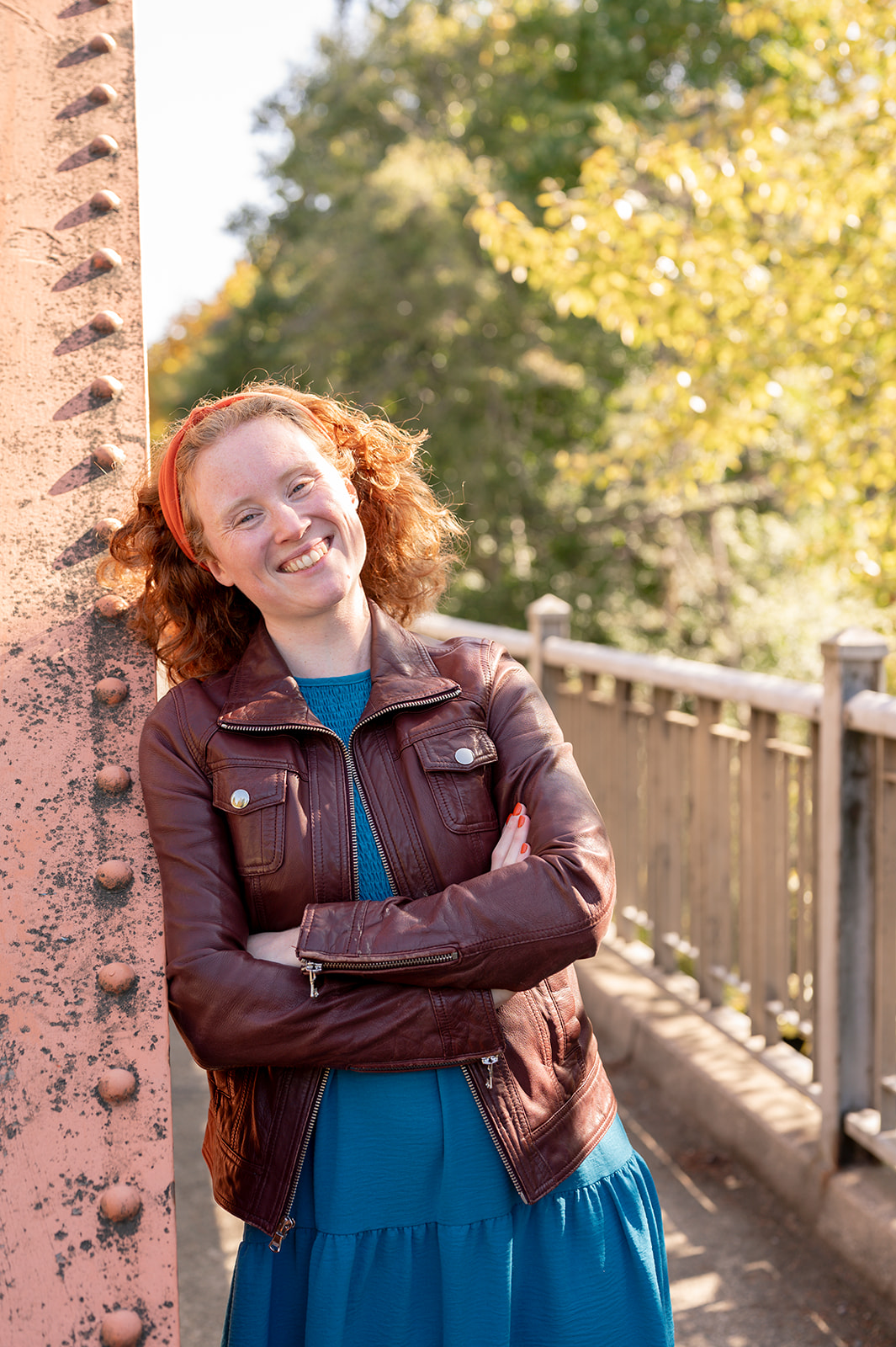 red-headed woman standing on bridge
